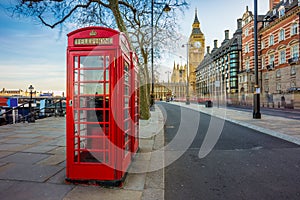 London, England - Traditional Old British red telephone box at Victoria Embankment with Big Ben