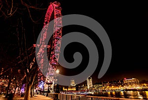 London Eye Giant Ferris Wheel illuminated at night in London, UK