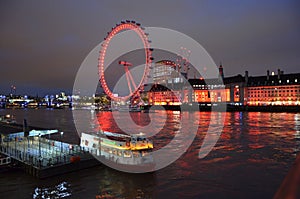 london eye at night on the river thames in london