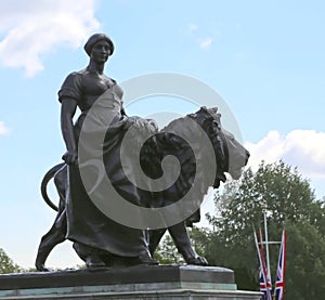 London, Great Britain -May 23, 2016: The Victoria Memorial, bronze figure with lion, representing Agriculture