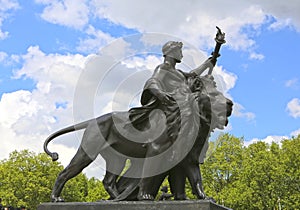 London, Great Britain -May 23, 2016: The Victoria Memorial, bronze figure with lion, representing Progress