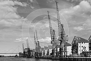 LONDON - JUNE 25 : Old dockside cranes alongside a waterfront de