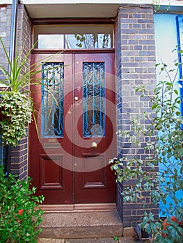 London, Notting hill, entrance with folliage and wooden door
