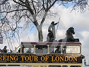 London Open-top Sightseeing Bus Tour moving near Boadicea statue chariot