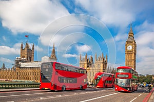 London with red buses against Big Ben in England, UK