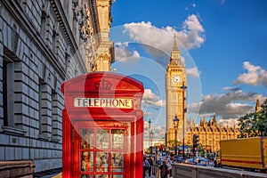London with red phone booth against Big Ben in England, UK