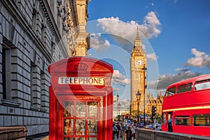 London with red phone booth against Big Ben in England, UK