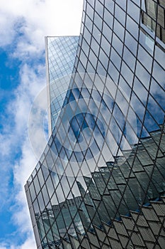 London, reflection of clouds in the windows of modern buildings