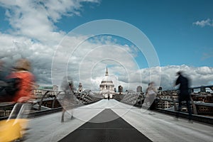 London`s St Paul and walking people on the Millennium Bridge