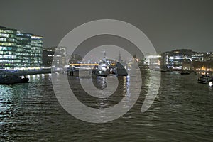 London skyline over river thames in night showing reflection