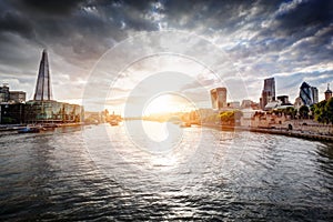 London skyline at sunset, England the UK. River Thames, the Shard, City Hall.