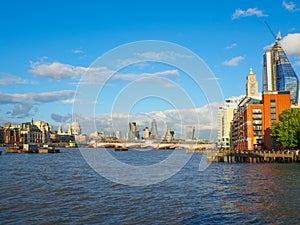 London skyline with a view of St Paul`s Cathedral, Blackfriars Bridge and skyscrapers of the City on a sunny afternoon.