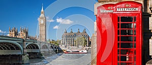 London symbols, Big Ben and Red Phone Booths with boat on river in England, UK