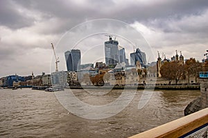London thames skyline with clouds and water in river