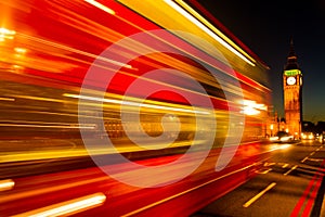 London traditional red bus in movement over the Westminster Bridge, London, UK