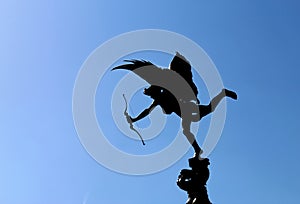LONDON, UK - AUGUST 2018: Eros statue with bow and arrow against blue sky in Piccadilly Circus