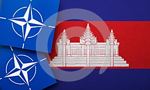 LONDON, UK - August 2022: NATO North Atlantic Treaty Organization military alliance logo on a Cambodia flag
