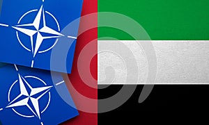 LONDON, UK - August 2022: NATO North Atlantic Treaty Organization military alliance logo on a UAE flag