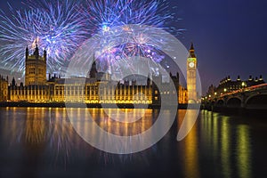 London, UK - Big Ben and Westminster Palace with fireworks during New Year`s celebration photo