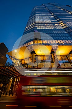 London, UK: 22 Bishopsgate or TwentyTwo in the City of London at dusk with a red bus