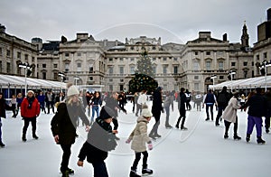 People skating on ice at the Somerset House Christmas Ice Rink. London, United Kingdom, December 2018.