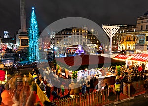 London, UK/Europe; 20/12/2019: Night view of Christmas market, Christmas tree and menorah in Trafalgar Square in London. Long