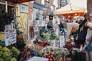 People buying flowers at Columbia Road Flower Market, London, UK