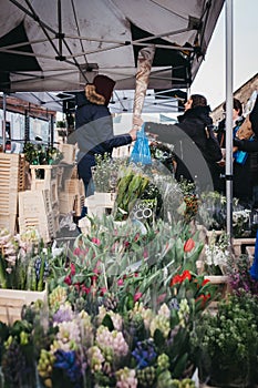 People buying flowers at Columbia Road Flower Market, London, UK