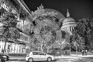 LONDON, UK - JULY 2ND, 2015: Modern buildings and St Paul Cathedral on the background at night