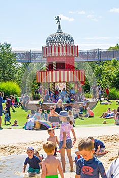 Children's play ground at hot summer day and kids playing with sand and water.