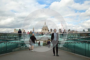 Tourists walking on milenium bridge in London