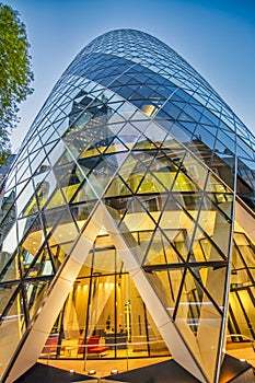 LONDON, UK - JUNE 2015: The modern glass buildings of the Swiss Re Gherkin. This tower is 180 meters tall and stands in the City