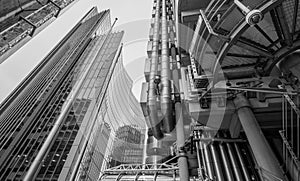 View looking upwards showing the Lloyds of London building designed by Richard Rogers and the Willis Building by Norman Foster. photo