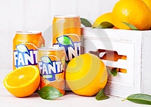LONDON, UK - MARCH 31, 2018: Aluminium tins of Fanta orange soft drink on white wooden background