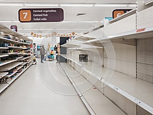 Empty shelves in canned goods and toiler paper aisle of Sainsburys supermarket in Golders Green, London, UK.