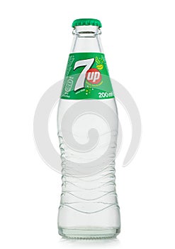 LONDON,UK - MAY 10, 2022 :  7UP classic lemon and lime soda in glass bottle on white background