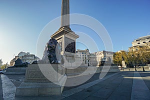 Nelson`s column and lion statue at Trafalgar Square for tourist attraction in London