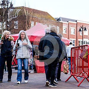 Two Senior Women Carrying Cups Of Takeaway Coffee Hot Beverage