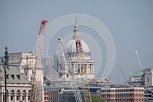 London UK. Panoramic view of the iconic dome of St Paul`s Cathedral, the River Thames, cranes and buildings under construction