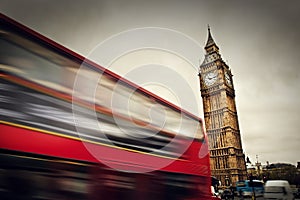 London, the UK. Red bus in motion and Big Ben