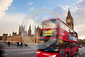 London, the UK. Red bus in motion and Big Ben