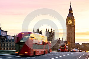 London, the UK. Red bus in motion and Big Ben, the Palace of Westminster. The icons of England