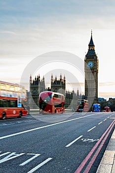 London, the UK. Red bus in motion and Big Ben, the Palace of Westminster. The icons of England