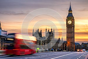 London, the UK. Red bus in motion and Big Ben, the Palace of Westminster. The icons of England