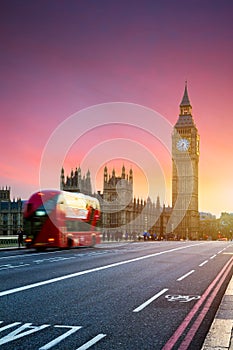 London, the UK. Red bus in motion and Big Ben, the Palace of Westminster. The icons of England