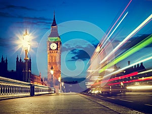 London, the UK. Red bus in motion and Big Ben