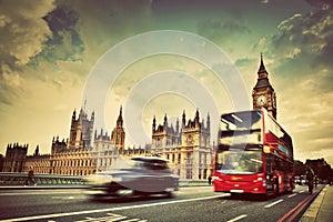 London, the UK. Red bus, taxi cab in motion and Bi