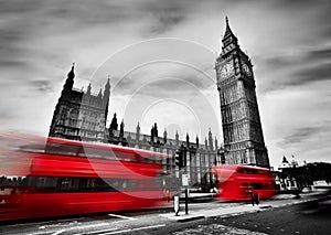 London, the UK. Red buses and Big Ben, the Palace of Westminster. Black and white