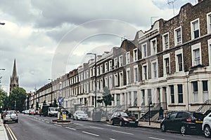 A row of typical British terrace houses on Kilburn Park Road in London