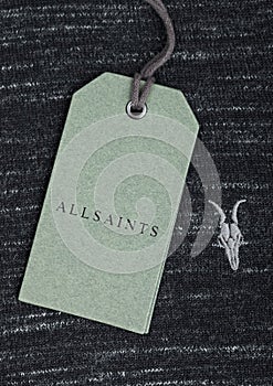 LONDON, UK - SEPTEMBER 09, 2020: ALLSAINTS logo and clothing tag on cotton fabric